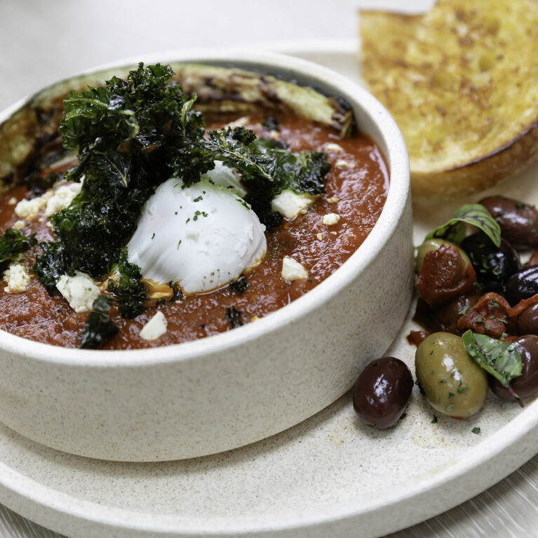 Sofia elevates comfort food with artful plating. Served on natural-toned ceramics, this Mediterranean-inspired dish blends bold flavors with an aesthetic that complements the café’s earthy design.