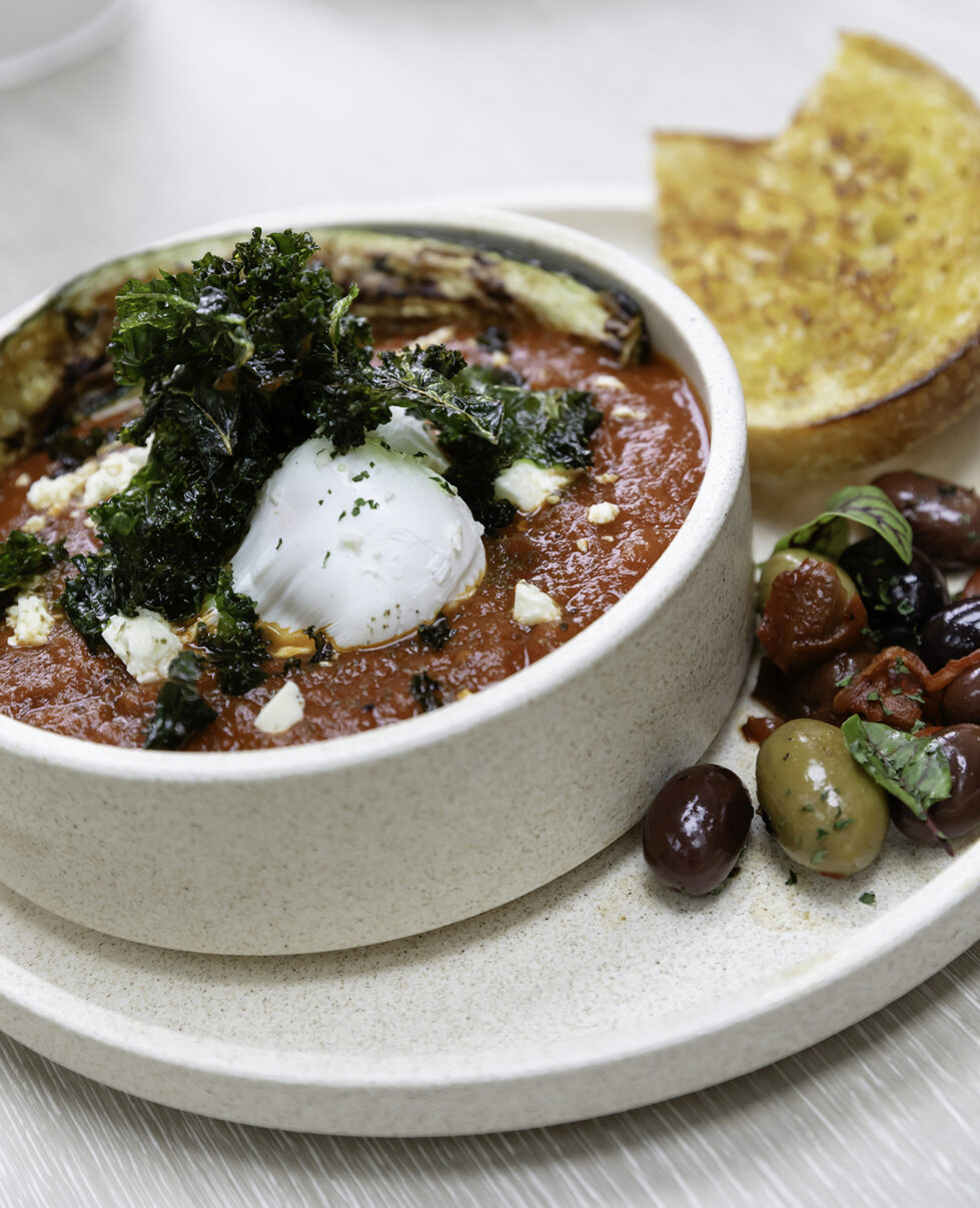 Sofia elevates comfort food with artful plating. Served on natural-toned ceramics, this Mediterranean-inspired dish blends bold flavors with an aesthetic that complements the café’s earthy design.