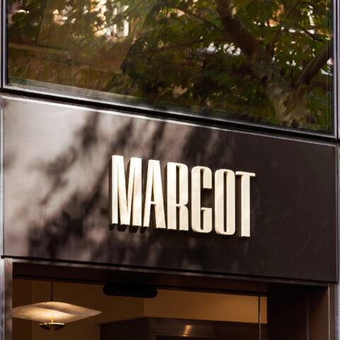 Margot Osteria’s entrance offers a first glimpse into the experience that awaits inside. Bold signage and grand windows give the space a confident presence, while warm lighting and accents of the signature Margot terracotta create a sense of character and charm.