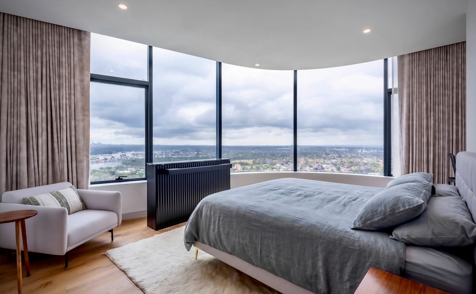 The master bedroom offers a serene retreat with expansive views, floor-to-ceiling windows, and luxurious furnishings. 