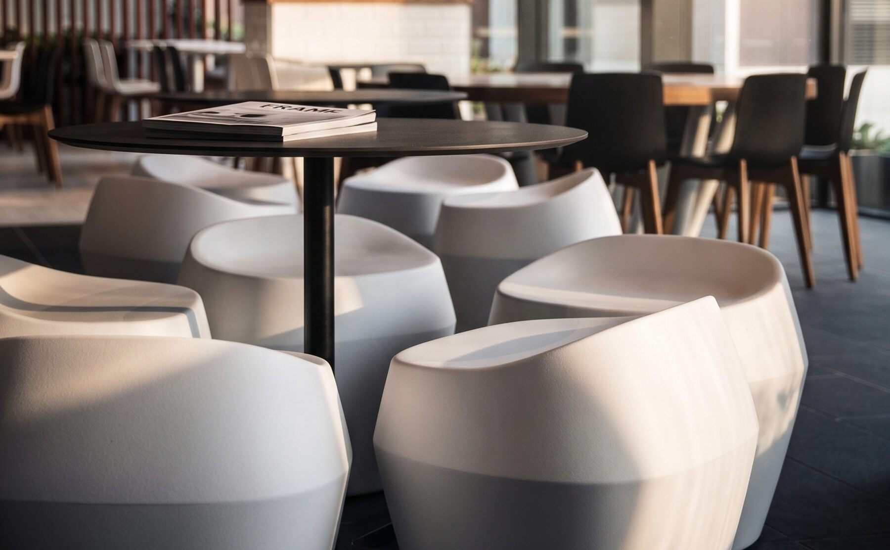 Commercial food court, molded composite stools, circular café tables, timber dining chairs, angular spatial layout, commercial floor tiles, community hub seating.