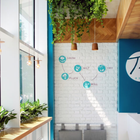 Retail store interior, white brick feature wall, window service counter, hanging ivy planter, industrial bulb pendant lights, circular brand signage.