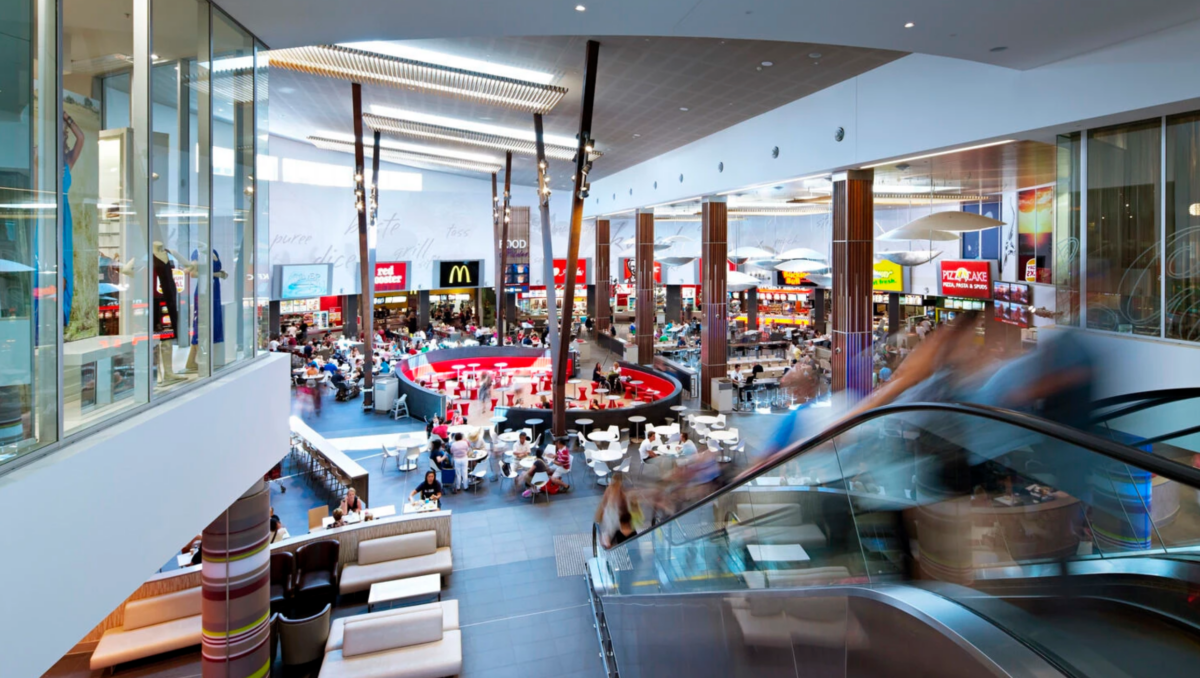 An elevated view overlooking a high-volume dining hall and public walkways.
