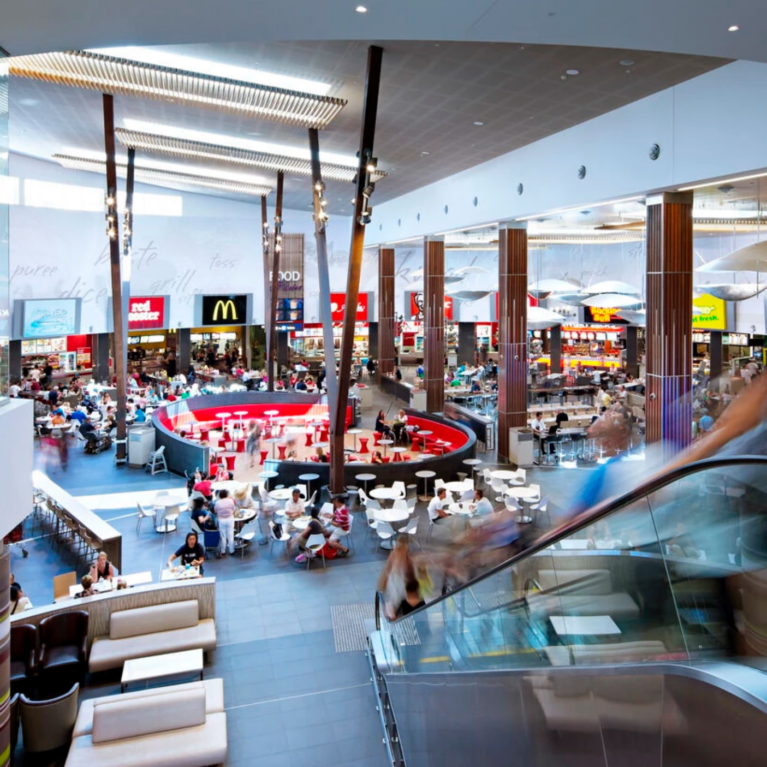 An elevated view overlooking a high-volume dining hall and public walkways.