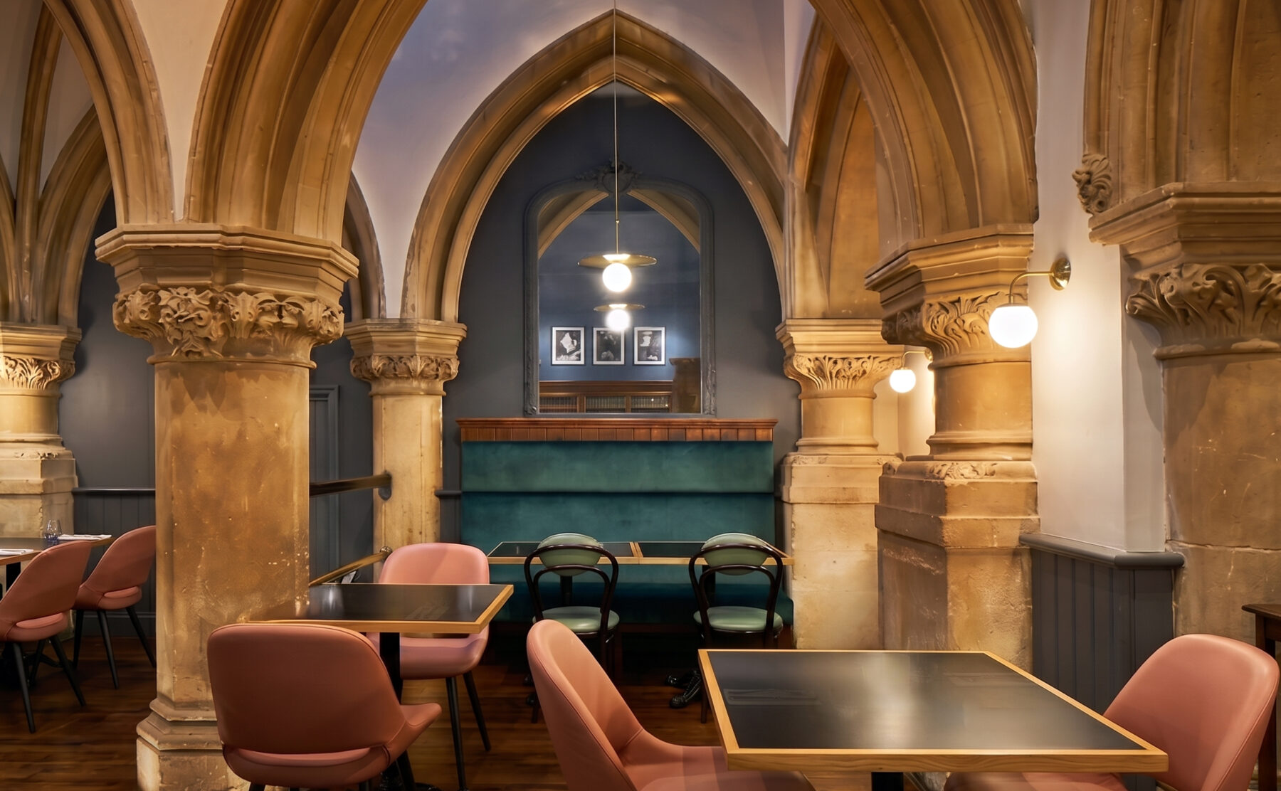 Intimate dining alcoves framed by historical stone colonnades.