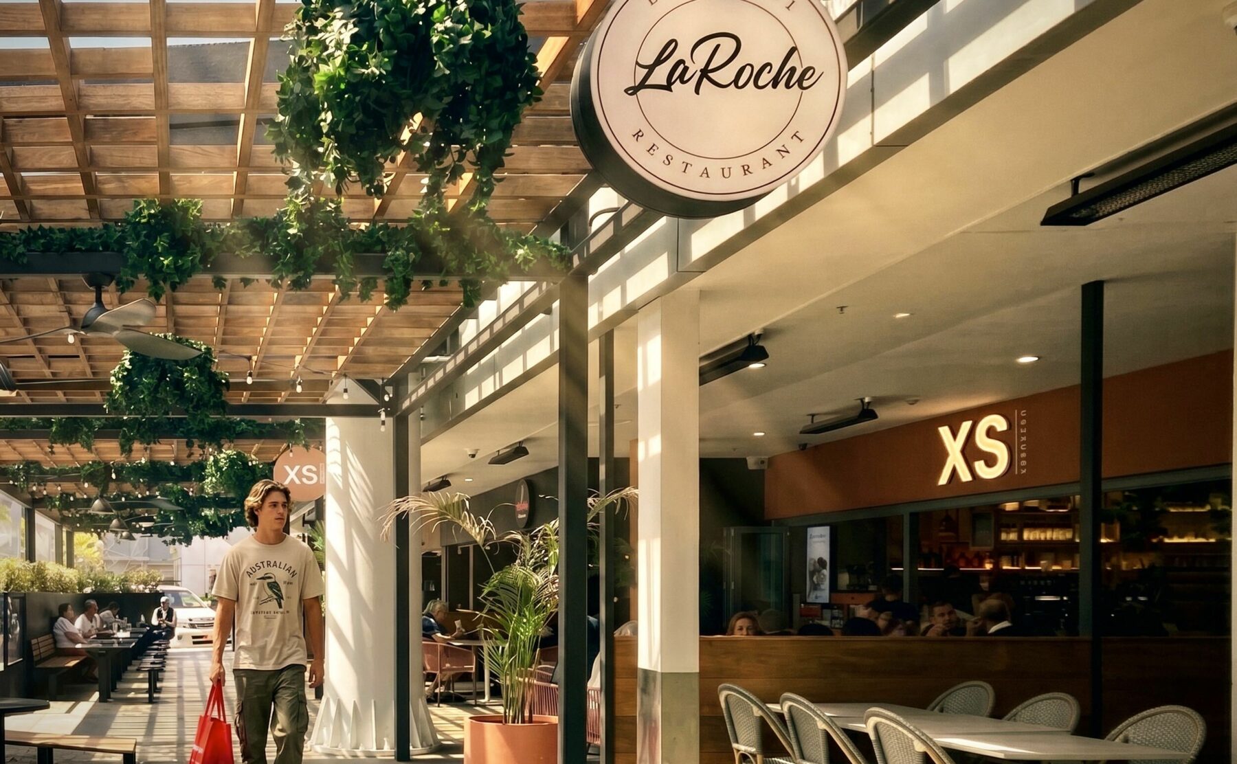 Timber pergola, glass roofing, dappled light, external dining, F&B precinct, black columns, stone paving, bench seating, string lights, hanging baskets, external signage, precinct landscaping, Sydney retail, community amenities.