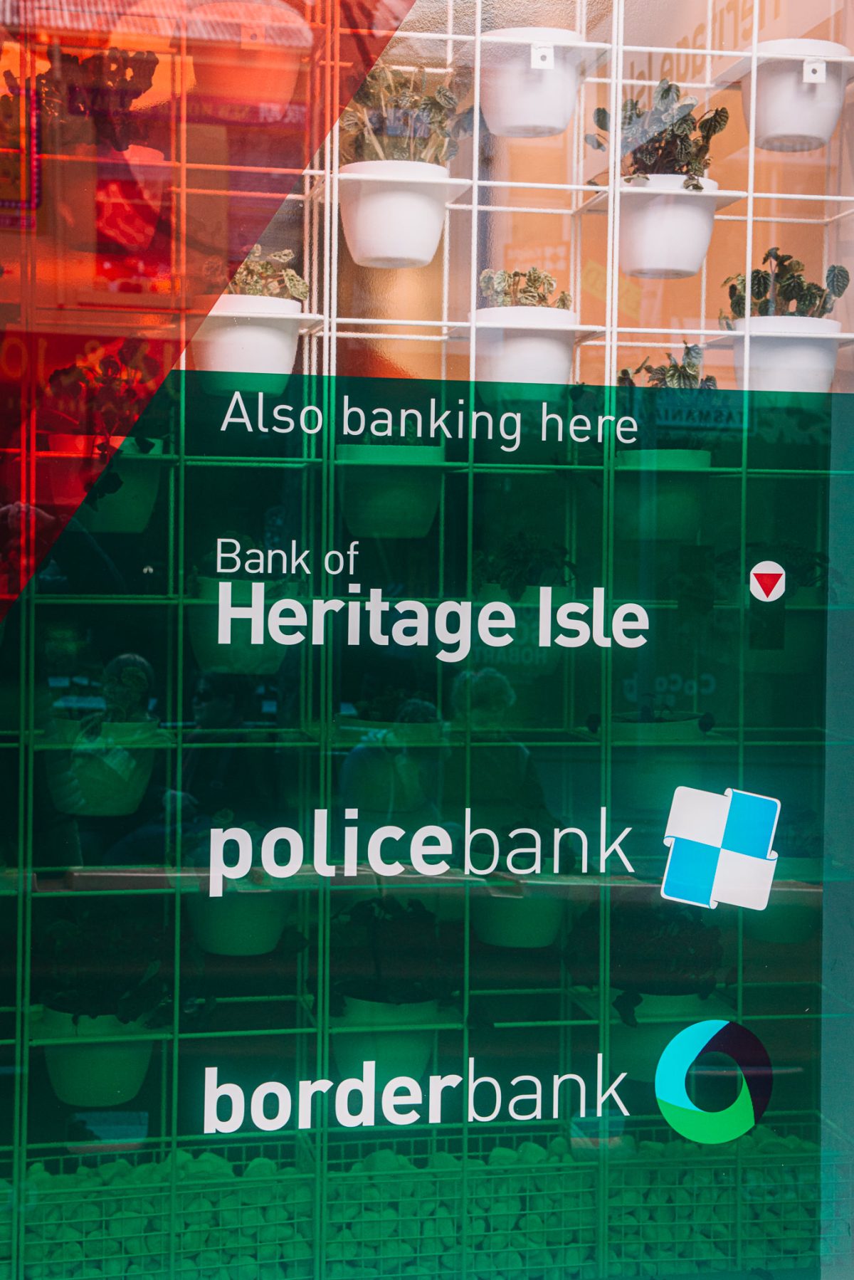 Heritage Bank’s branded shopfront highlights its affiliations, presenting a cohesive identity with logos and text for associated financial institutions.