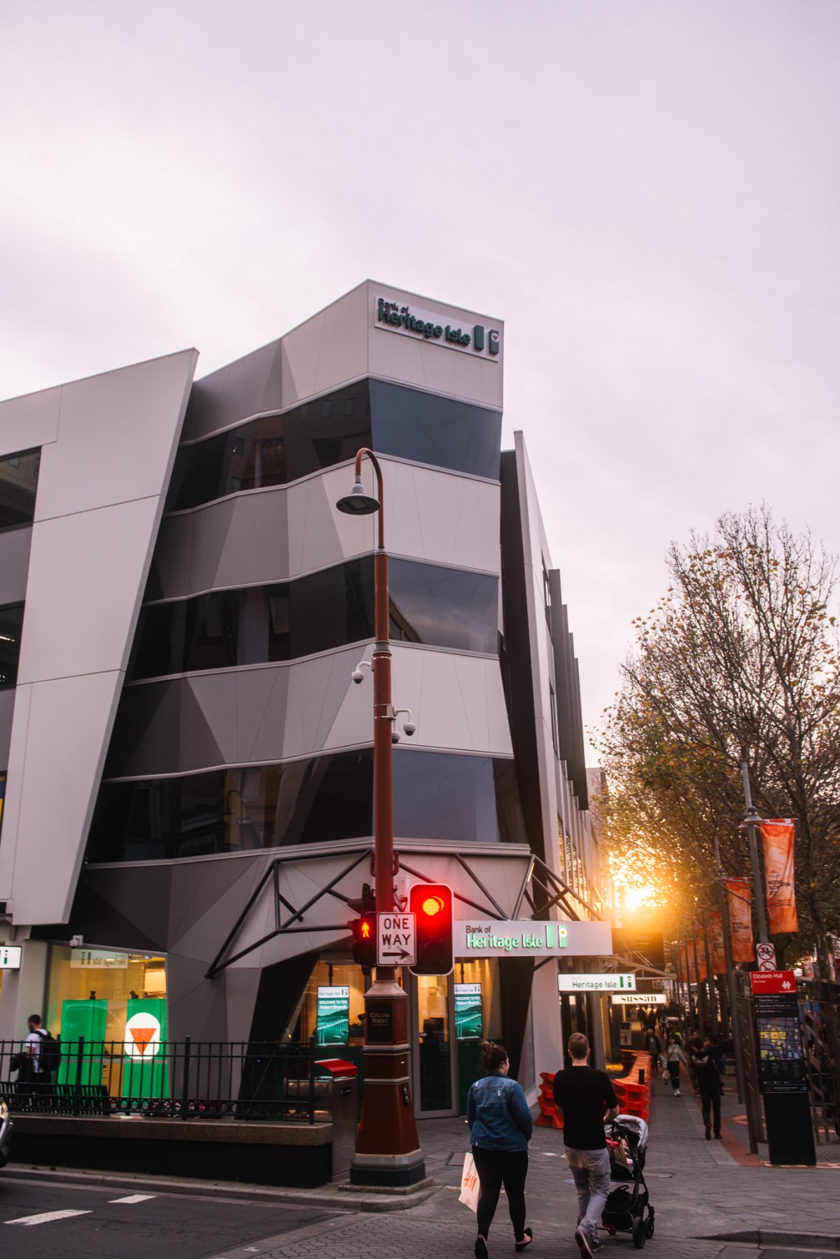 The modern facade lights up at night, drawing attention with striking geometric designs and illuminated branding, creating a welcoming atmosphere for customers.