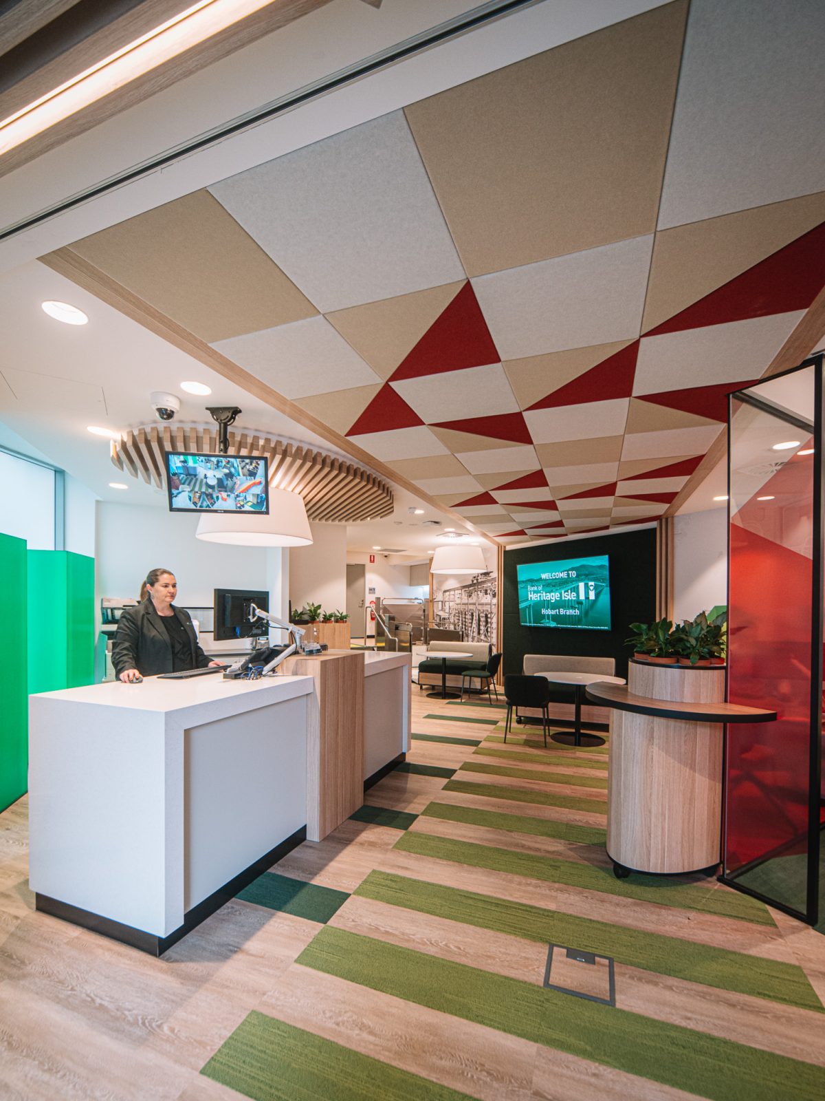 The modern reception area combines functional design with warm, geometric details, welcoming customers with a minimalist counter, seating areas, and natural accents.