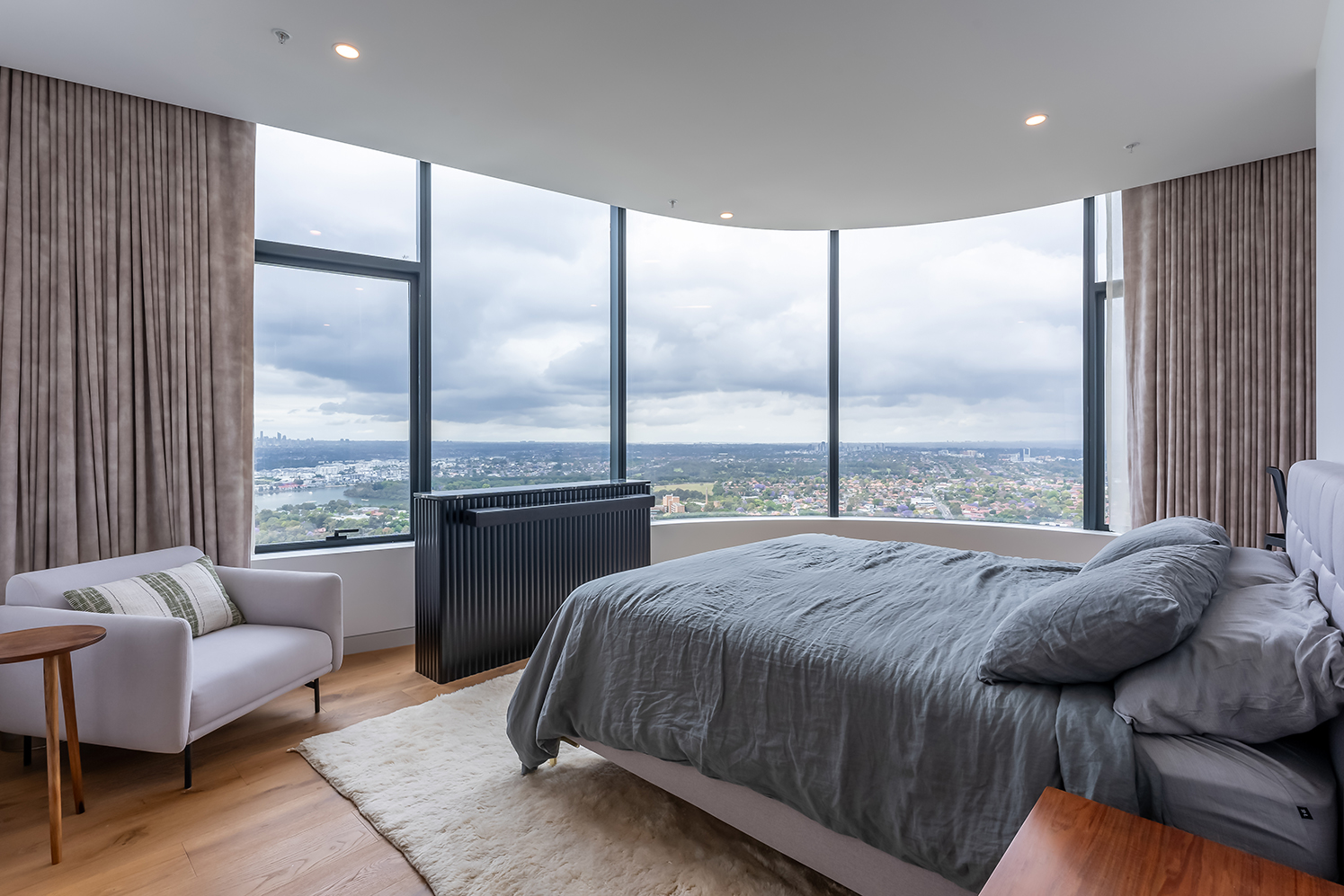 The master bedroom offers a serene retreat with expansive views, floor-to-ceiling windows, and luxurious furnishings. 