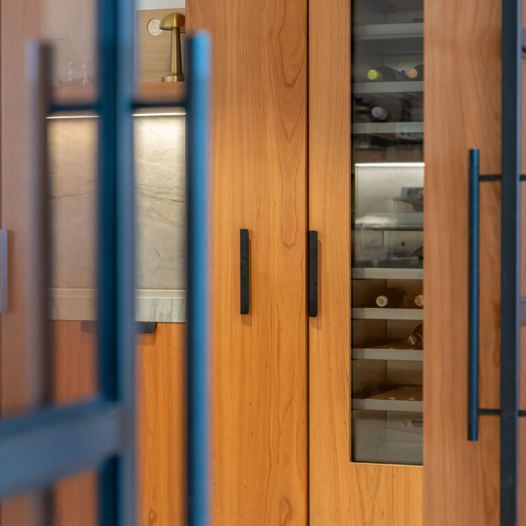 A dedicated wine storage area in the kitchen adds luxury and convenience, with temperature-controlled shelving and glass doors that showcase the collection.