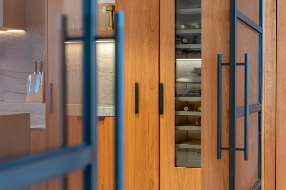 A dedicated wine storage area in the kitchen adds luxury and convenience, with temperature-controlled shelving and glass doors that showcase the collection.