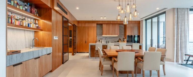 The open-concept kitchen and dining area featuring modern design with warm wood tones and practical materials.