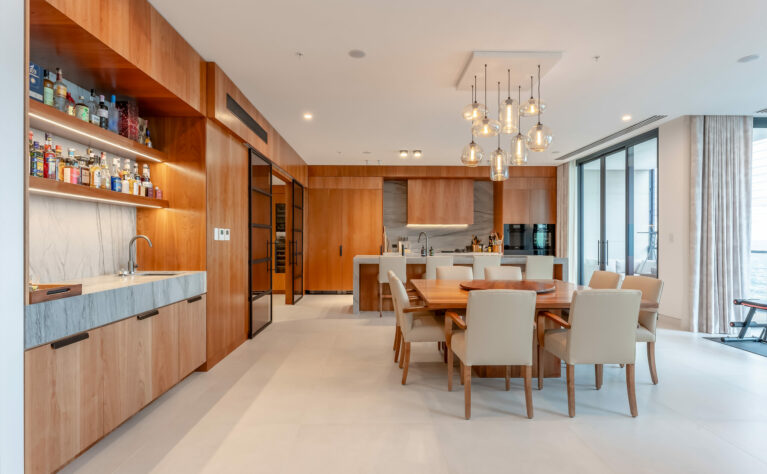 The open-concept kitchen and dining area featuring modern design with warm wood tones and practical materials.