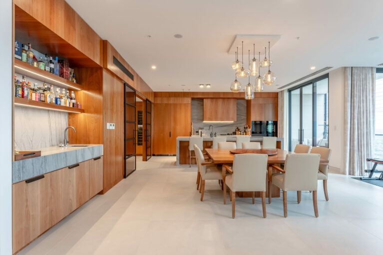 The open-concept kitchen and dining area featuring modern design with warm wood tones and practical materials.