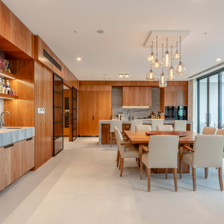 The open-concept kitchen and dining area featuring modern design with warm wood tones and practical materials.