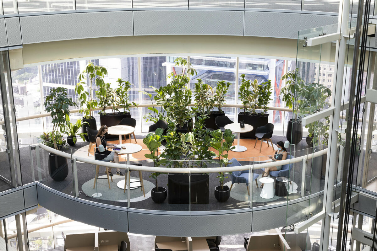 Intimate balcony pods float above the city, softened by circular rugs, lush greenery and light-filled glass-steel edges, designed as overflow sanctuaries for informal gatherings or quiet solo retreat.