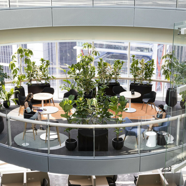 Intimate balcony pods float above the city, softened by circular rugs, lush greenery and light-filled glass-steel edges, designed as overflow sanctuaries for informal gatherings or quiet solo retreat.