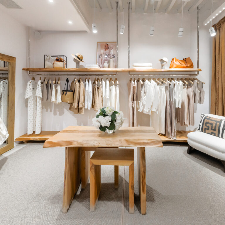 A harmonious blend of soft neutrals and warm wood tones defines this boutique interior. Thoughtful layering of materials, from raw timber to textured textiles, enhances the serene atmosphere while elevating the shopping experience.