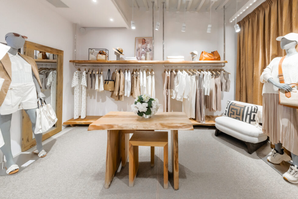 A harmonious blend of soft neutrals and warm wood tones defines this boutique interior. Thoughtful layering of materials, from raw timber to textured textiles, enhances the serene atmosphere while elevating the shopping experience.