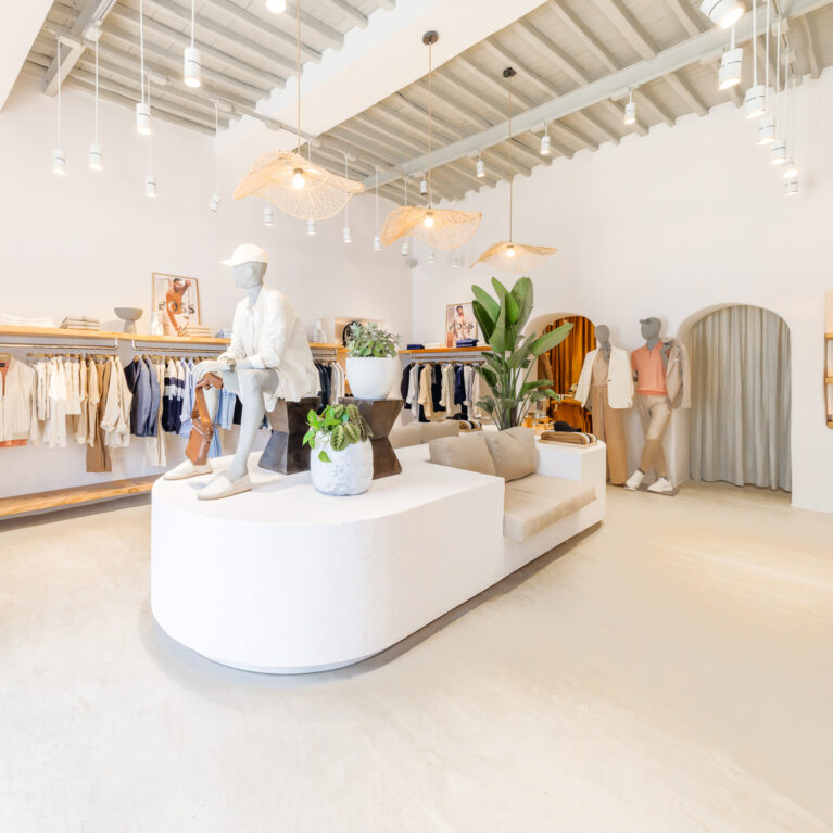 The interior blends soft neutrals, organic textures, and modern minimalism, creating an inviting and relaxed shopping experience. Thoughtful lighting and natural accents enhance the boutique’s effortless style, making it a perfect reflection of its island setting.