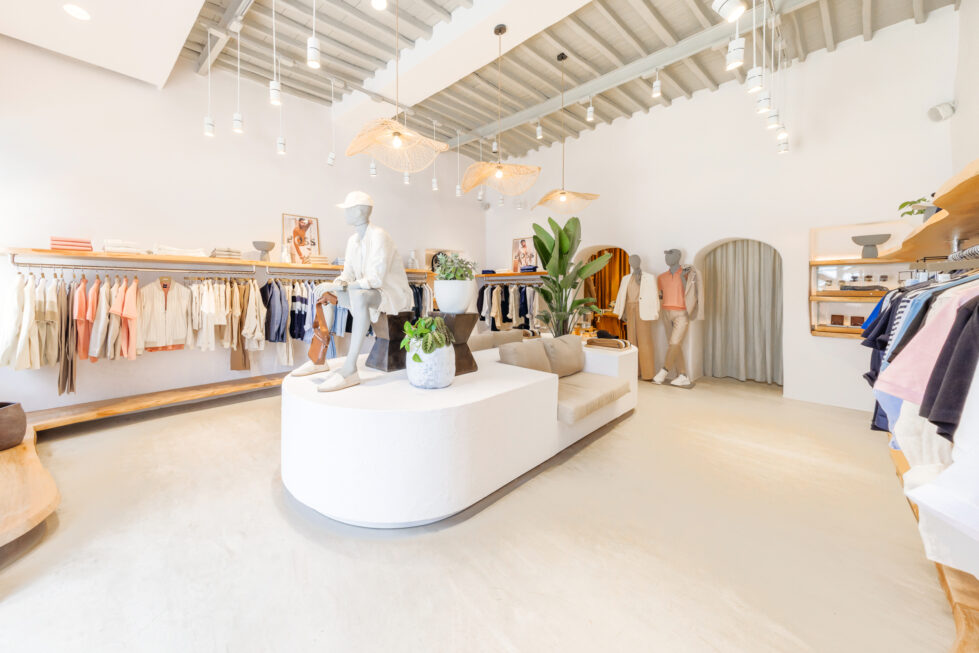 The interior blends soft neutrals, organic textures, and modern minimalism, creating an inviting and relaxed shopping experience. Thoughtful lighting and natural accents enhance the boutique’s effortless style, making it a perfect reflection of its island setting.