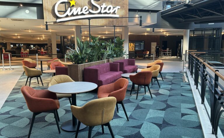 Bold colours, plush upholstery, and lush greenery bring warmth and vibrancy to the communal lounge zones.