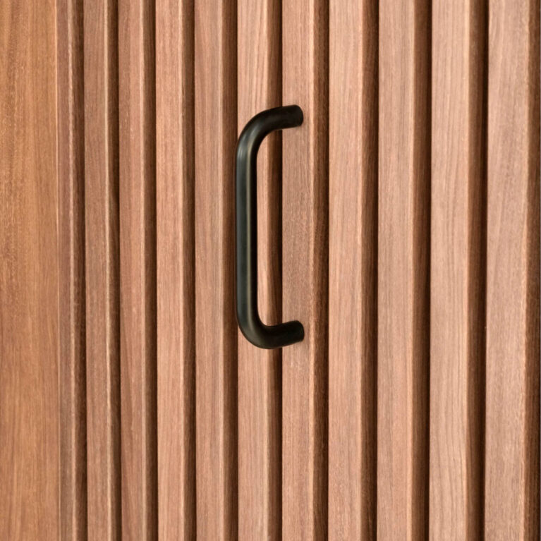 Vertical timber battens, matte black door handle, architectural joinery, concealed door integration, tactile wood cladding, custom millwork detail, commercial interior fit-out, timber wall feature