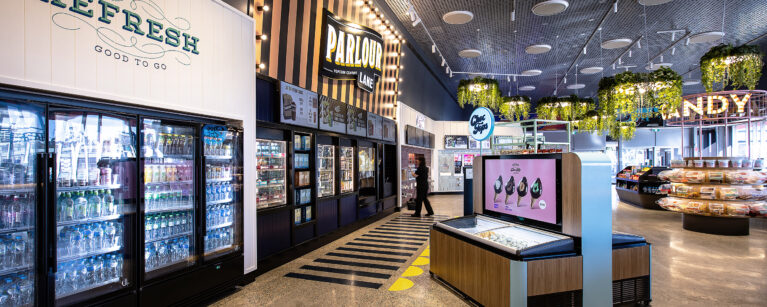 A cohesive grab-and-go and popcorn offer framed by bold branding and clear sightlines.