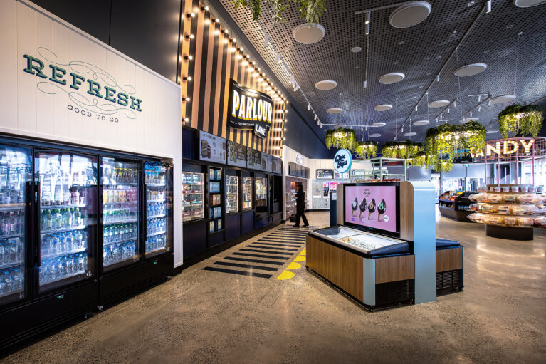 A cohesive grab-and-go and popcorn offer framed by bold branding and clear sightlines.