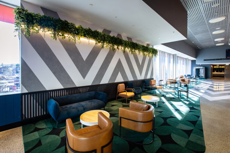 A relaxed, design-led lounge that elevates pre-show dwell time with comfort, colour and hospitality cues.