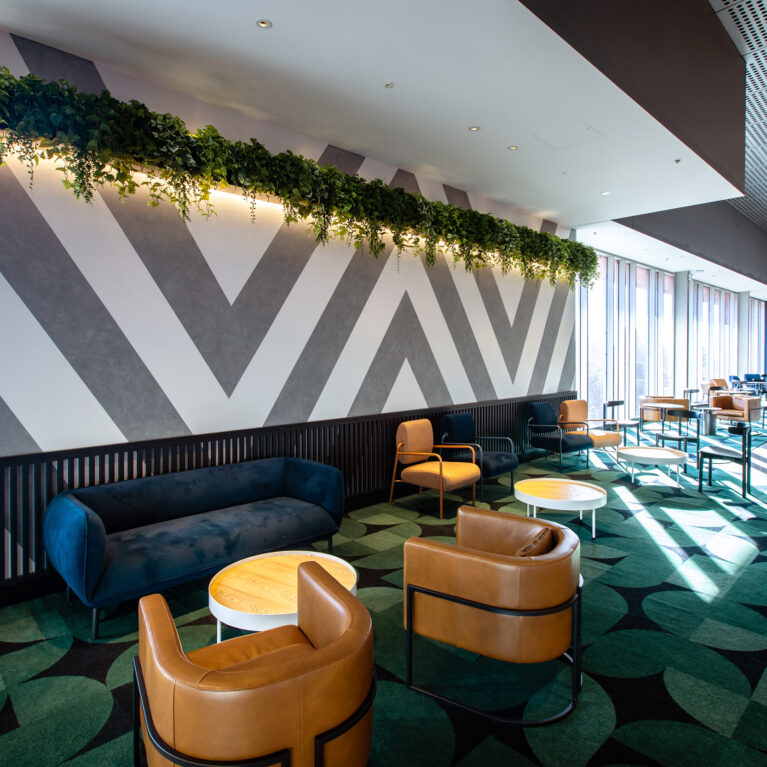 A relaxed, design-led lounge that elevates pre-show dwell time with comfort, colour and hospitality cues.