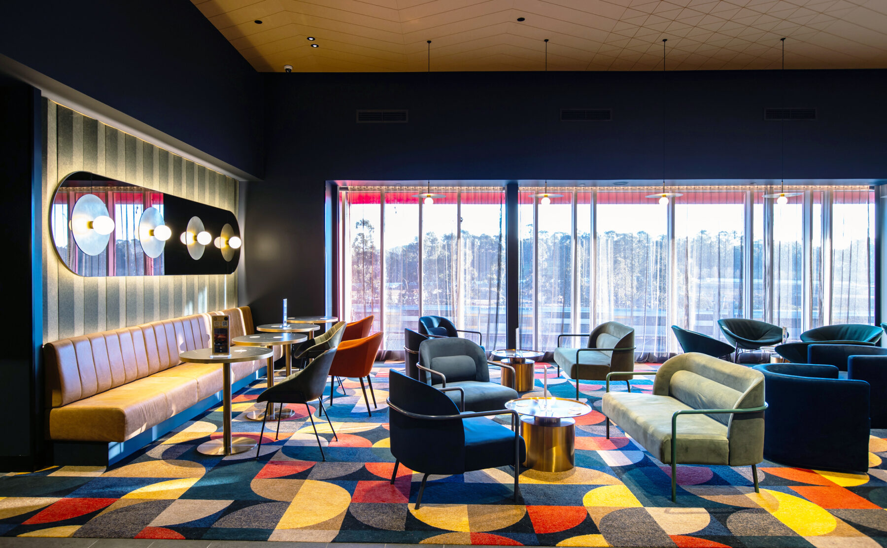 A richly layered lounge setting defined by colour, texture and a cinematic sense of occasion.