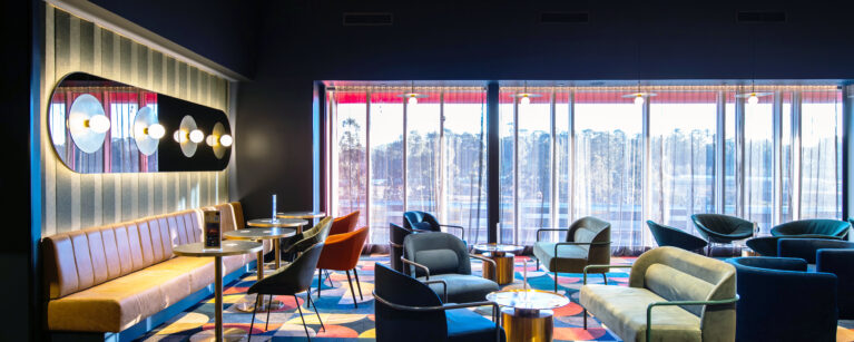 A richly layered lounge setting defined by colour, texture and a cinematic sense of occasion.