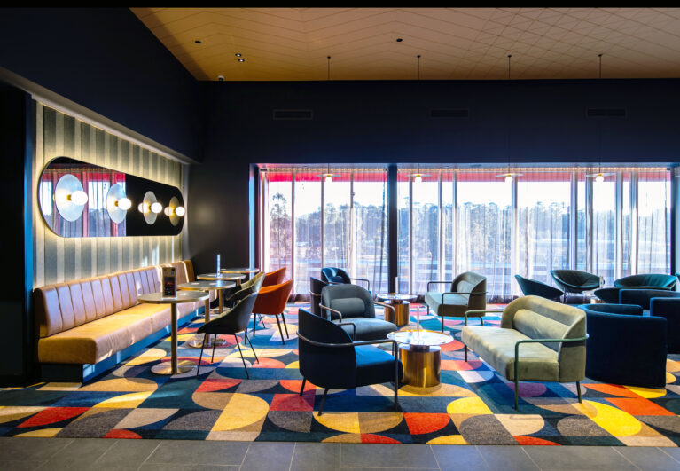 A richly layered lounge setting defined by colour, texture and a cinematic sense of occasion.