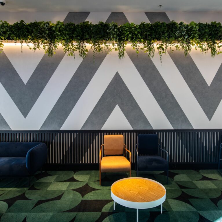 Unwind in the Contemporary Cinema Lobby — a vibrant gathering space before the feature begins.