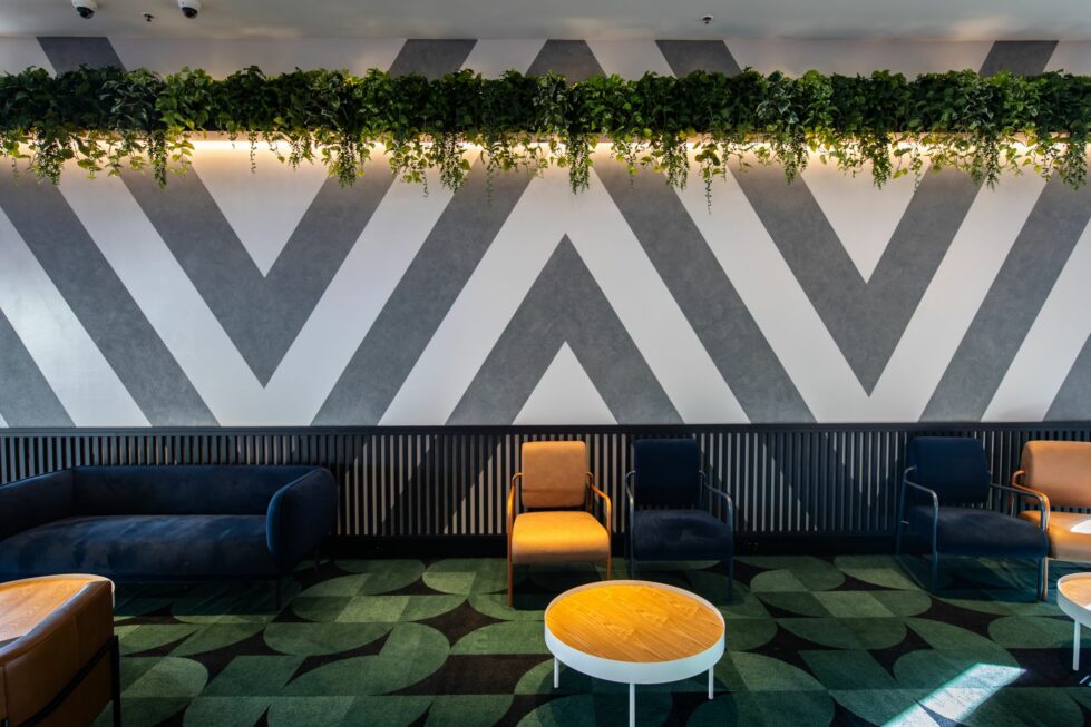 Unwind in the Contemporary Cinema Lobby — a vibrant gathering space before the feature begins.