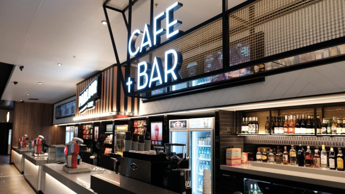 The cafe and bar canopy with modern signage and sleek metal framing, adding style to the cinema’s lobby.