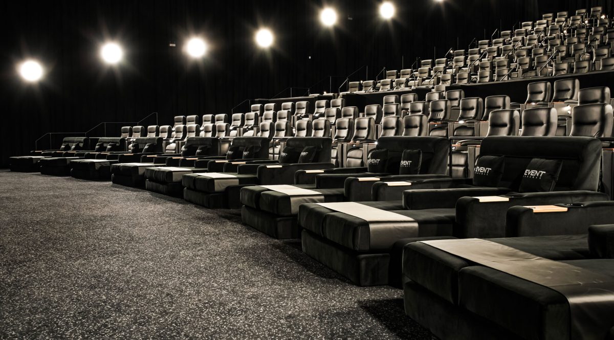 A luxurious Vmax cinema room featuring plush recliners, modern tiered seating, and high-end materials for ultimate comfort.