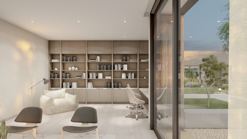 This library features built-in timber shelving, a cozy reading nook with a plush armchair, and sleek computer workstations. The open glass wall connects the interior to landscaped views, creating a tranquil yet functional space for study and relaxation.