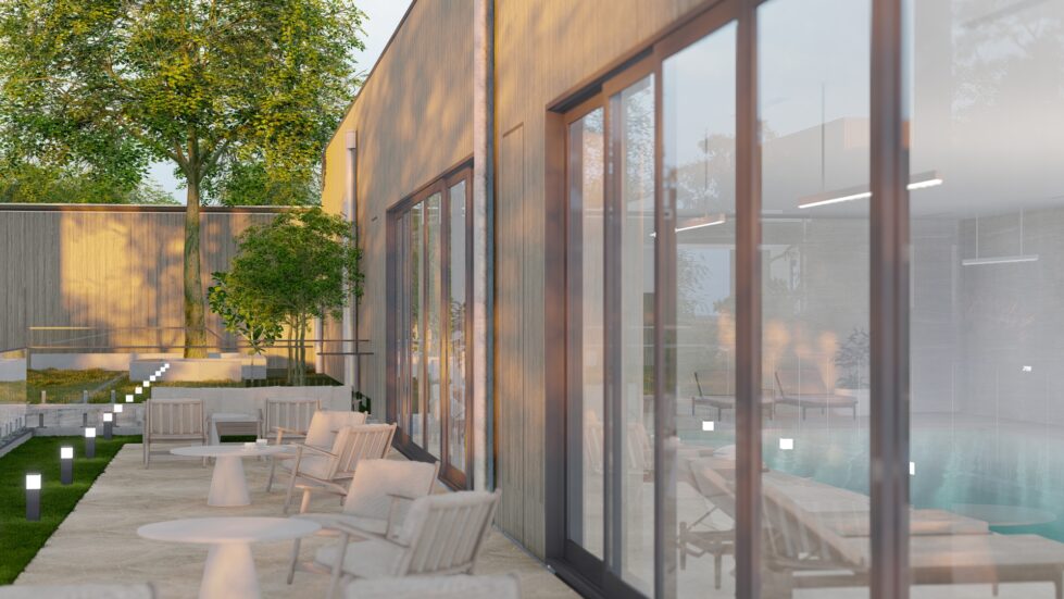 This outdoor sanctuary lounge features timber-framed seating and greenery on Torino Crazy Paving. Large glass doors connect the lounge to the indoor pool, creating a seamless transition between the tranquil outdoor space and the serene aquatic environment.