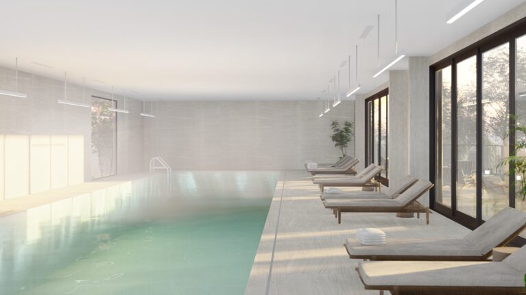 This serene indoor pool features Neolith Strata Argentum tiles, ergonomic timber-framed loungers, and soft natural lighting. Floor-to-ceiling glass doors connect the pool area to the outdoor sanctuary, offering a calming space that seamlessly blends relaxation with design sophistication.