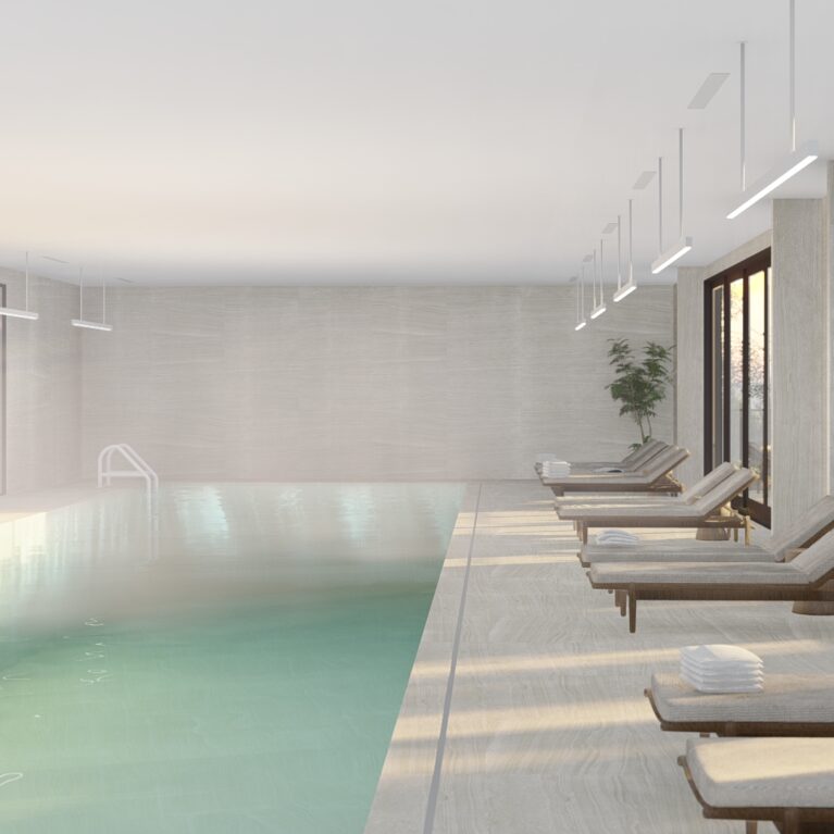 This serene indoor pool features Neolith Strata Argentum tiles, ergonomic timber-framed loungers, and soft natural lighting. Floor-to-ceiling glass doors connect the pool area to the outdoor sanctuary, offering a calming space that seamlessly blends relaxation with design sophistication.