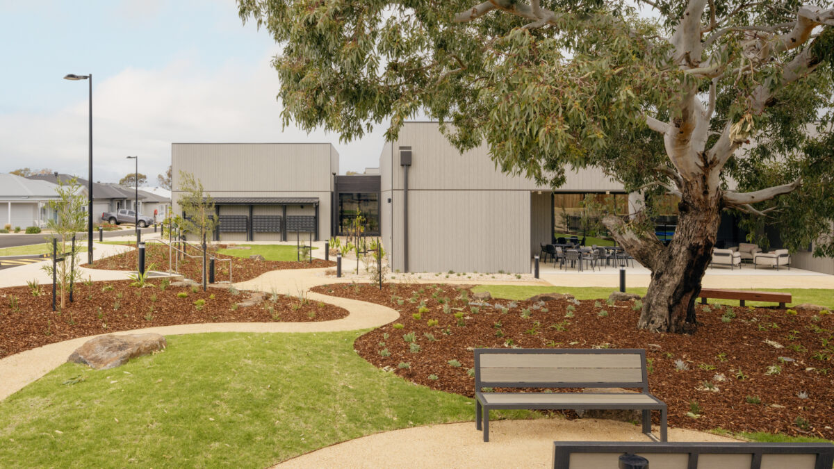 Curving paths stitch together lawns, native planting and shaded seating. The clubhouse reads as a series of calm pavilions, while mature eucalypts lend character and scale. It’s an easy landscape to stroll, pause and meet neighbours in.