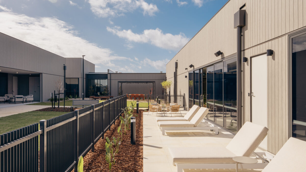 A calm, private sun deck edges the pool hall, stepping out to citrus-toned planting and views of the courtyard. Generous loungers, café settings and a low fence keep the space sociable yet secure—perfect for a slow morning or post-swim pause.