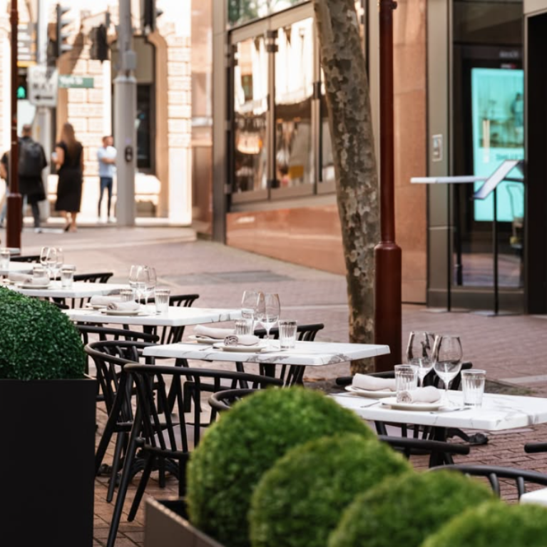 Margot Osteria’s alfresco area offers a relaxed, sunlit setting by day—perfect for savouring authentic Italian cuisine—and transforms into a warmly lit, inviting space by night, ideal for evening drinks and lingering conversations.