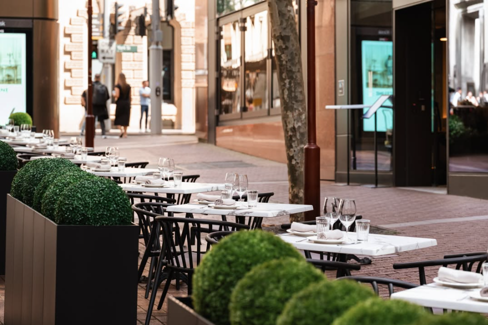 Margot Osteria’s alfresco area offers a relaxed, sunlit setting by day—perfect for savouring authentic Italian cuisine—and transforms into a warmly lit, inviting space by night, ideal for evening drinks and lingering conversations.