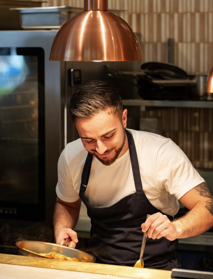 At Margot Osteria, the open kitchen becomes a focal point of the dining journey, where guests are invited to watch the chefs at work—a subtle yet engaging touchpoint that adds authenticity and connection.