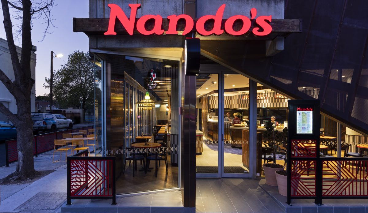 High street corner site featuring copper architectural elements and integrated al fresco dining areas.