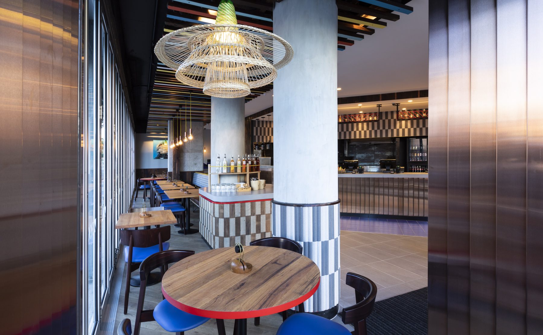 An interior perspective showcasing custom tiling, timber furniture, and statement lighting.